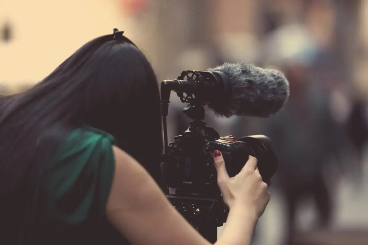 A photographer holding a camera